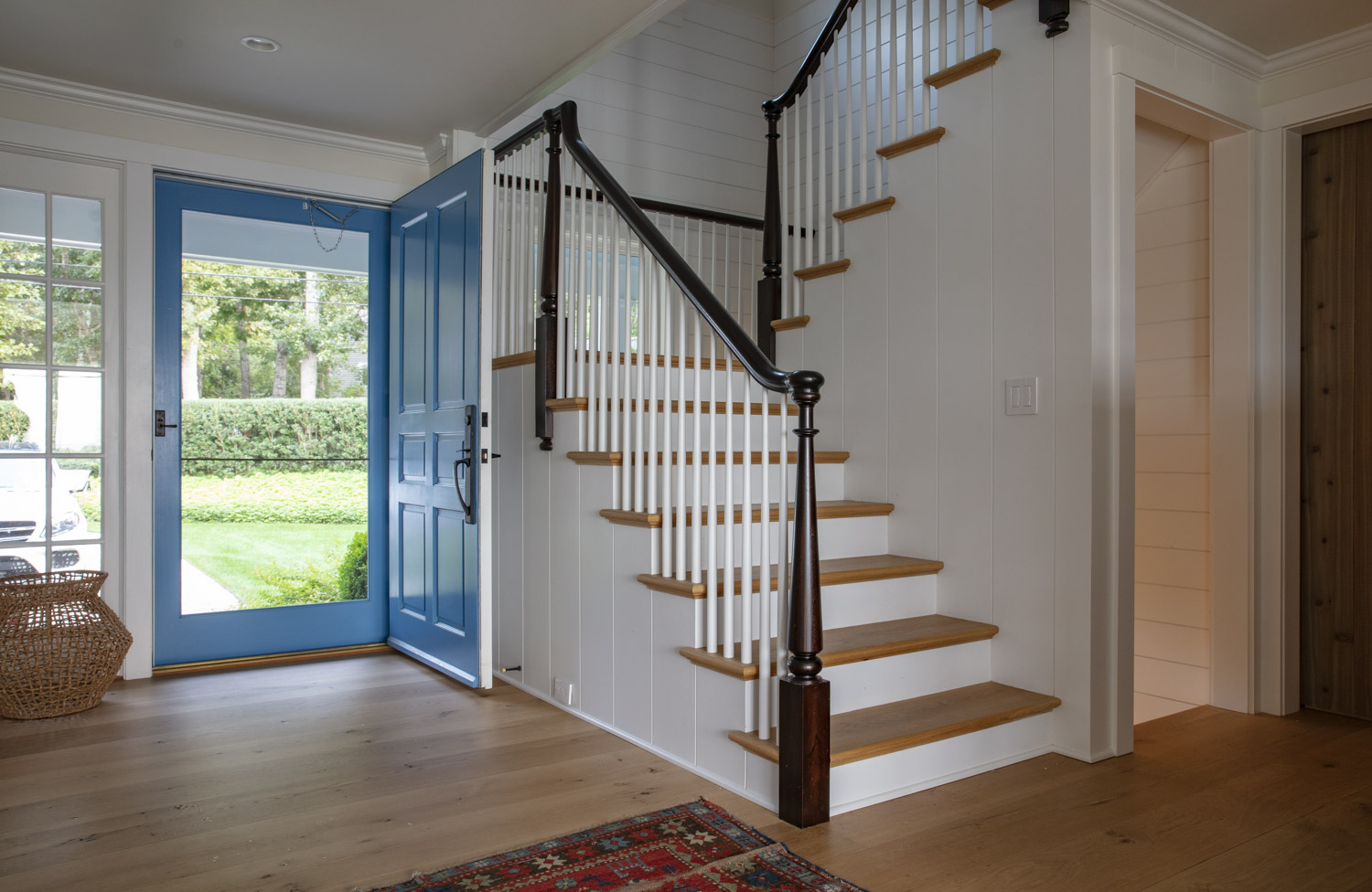 Water Hole blue door welcomes you. Build by Bruce Helier Builders.